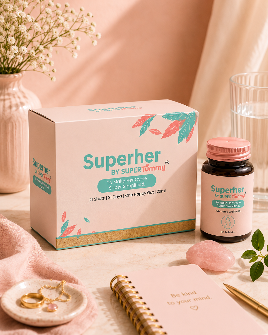 Superher by Super Tummy product packaging on a table with a notebook and small plant.